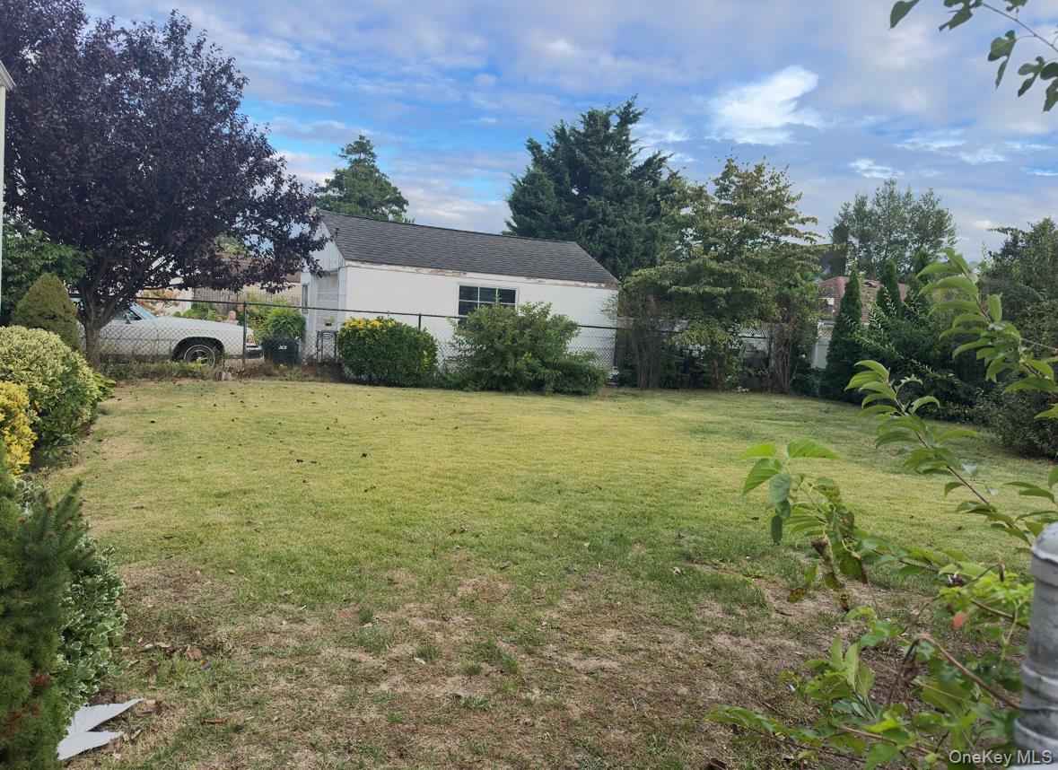 484 Chelsea Road Oceanside, NY 11572 - Photo 16 of 16 a view of a garden with a house