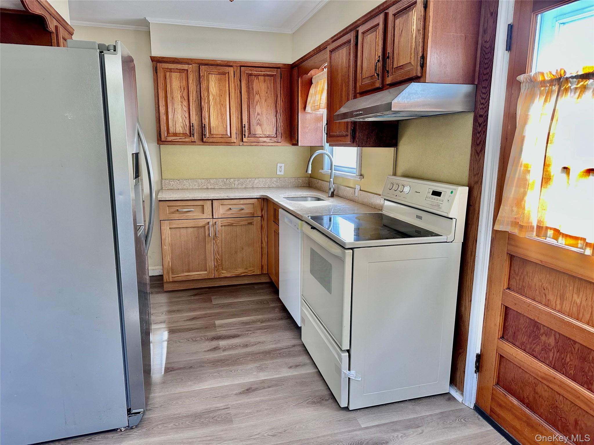 484 Chelsea Road Oceanside, NY 11572 - Photo 4 of 16 a kitchen with a sink a stove and refrigerator