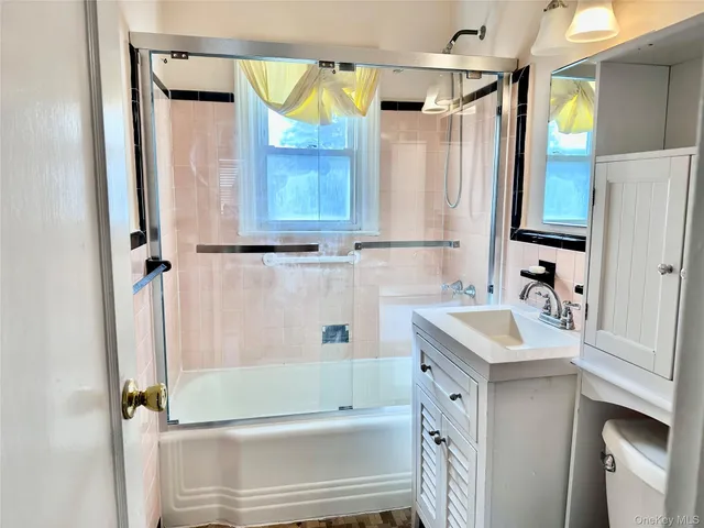 a bathroom with a sink a mirror and a shower