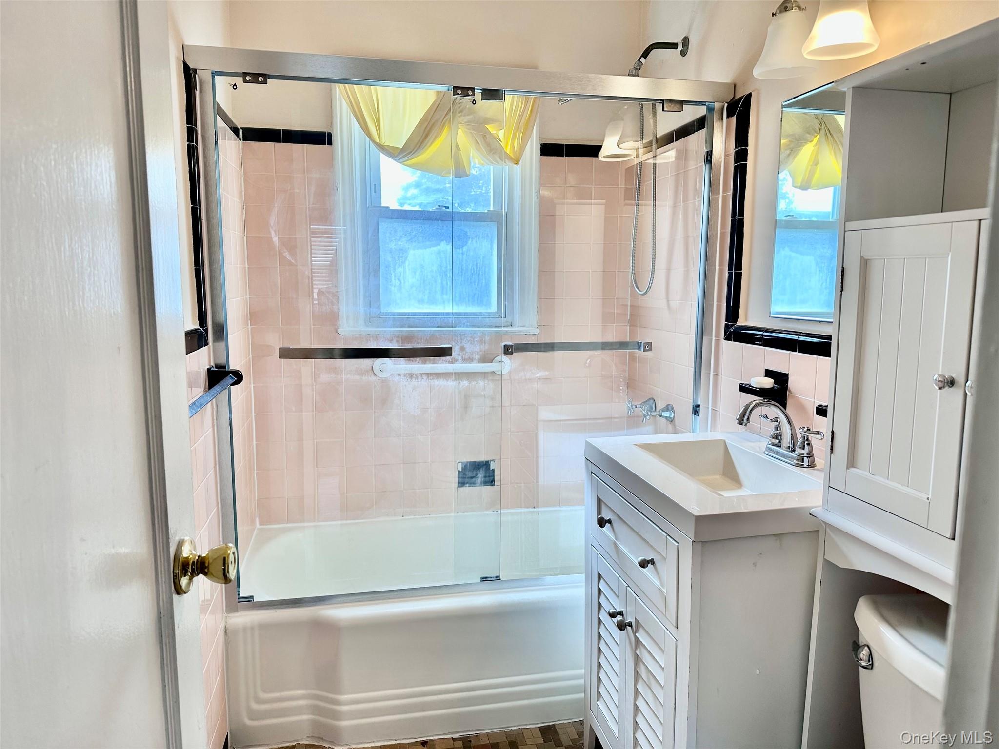484 Chelsea Road Oceanside, NY 11572 - Photo 8 of 16 a bathroom with a sink a mirror and a shower