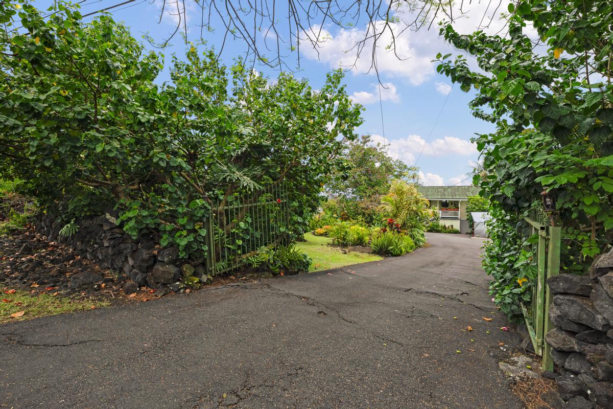 85-4563 Hawaii Belt Road Captain Cook, HI 96704 - Photo 30 of 30 a view of a street with potted plants and large trees