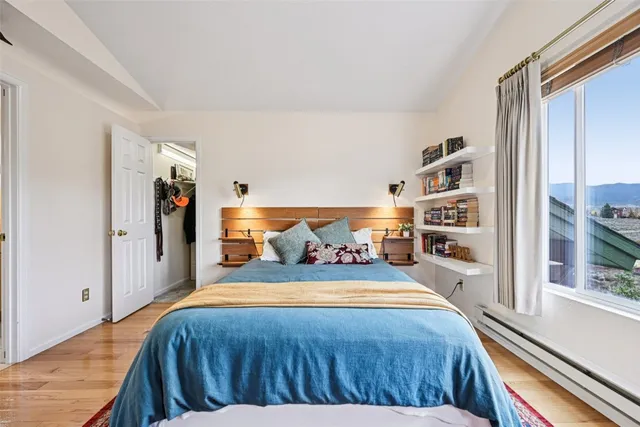 a bedroom with a bed furniture and a book shelf