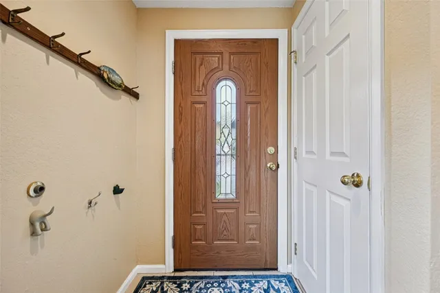 a living room with furniture kitchen view and a large window