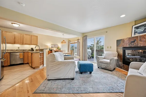 a kitchen with stainless steel appliances granite countertop a sink stove refrigerator and cabinets