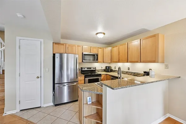 a stove top oven sitting inside of a kitchen