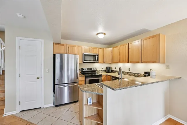 a stove top oven sitting inside of a kitchen