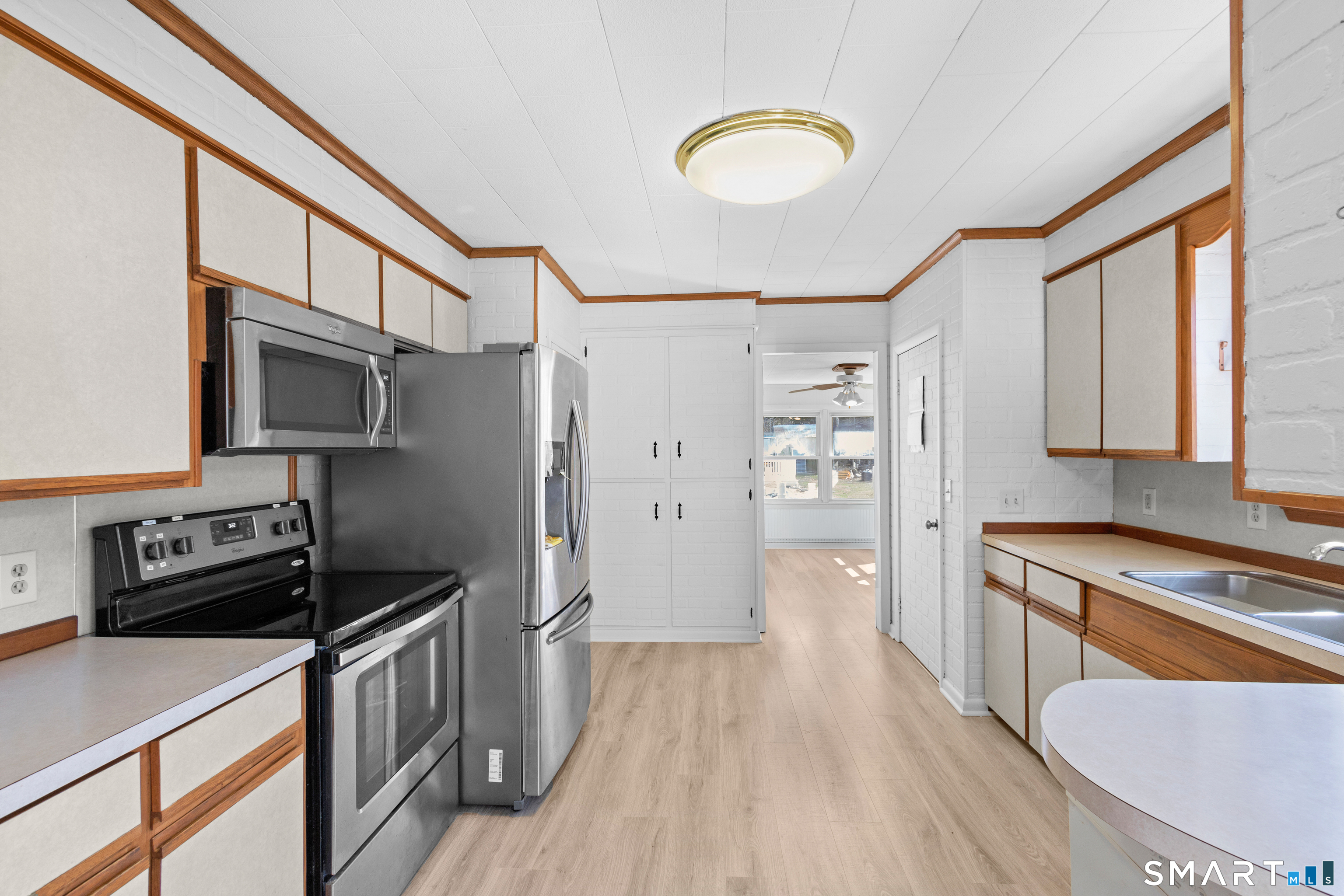 43 Woodward Street Killingly, CT 06239 - Photo 14 of 28 a kitchen with stainless steel appliances a stove refrigerator sink and wooden floor