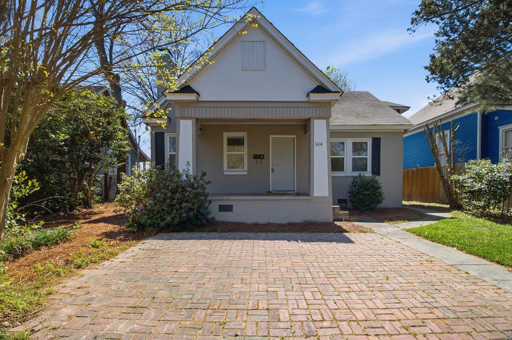 1404 18th Street Columbus, GA 31901 - Photo 1 of 20 a front view of a house with a yard and a garden