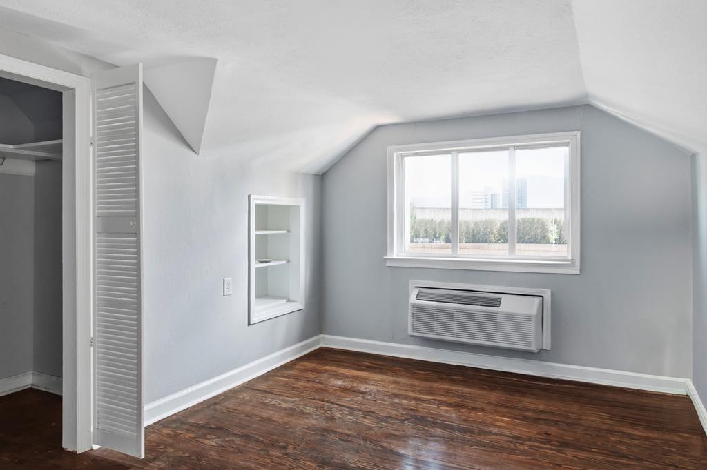1404 18th Street Columbus, GA 31901 - Photo 11 of 20 a view of an empty room with a window and wooden floor