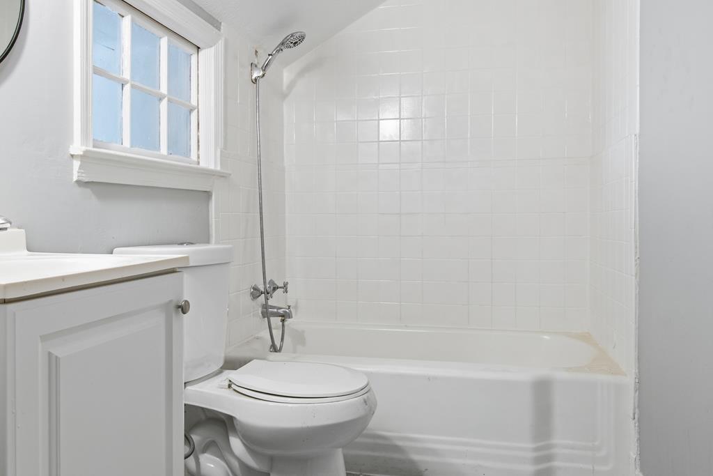 1404 18th Street Columbus, GA 31901 - Photo 12 of 20 a bathroom with a sink toilet and shower