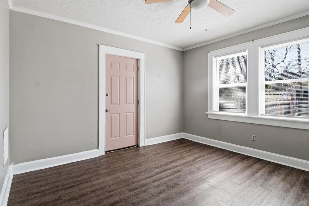 1404 18th Street Columbus, GA 31901 - Photo 15 of 20 a view of an empty room with wooden floor and a window