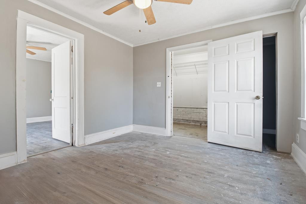 1404 18th Street Columbus, GA 31901 - Photo 19 of 20 an empty room with cabinet and a ceiling fan