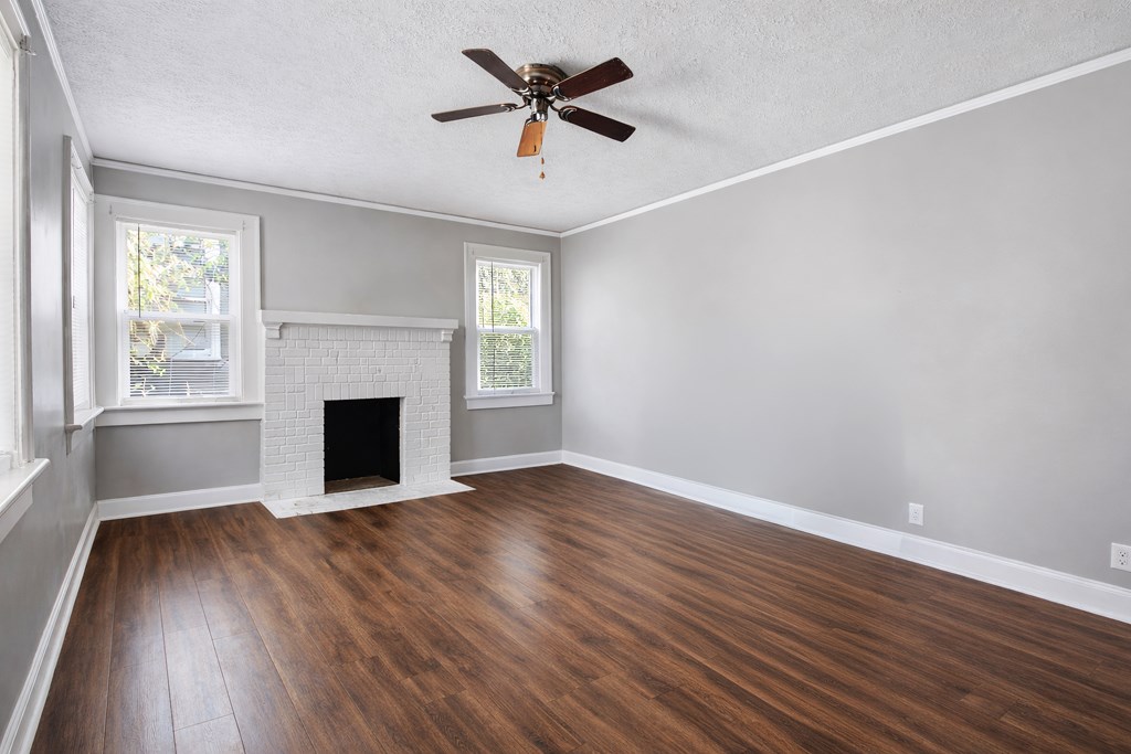 1404 18th Street Columbus, GA 31901 - Photo 2 of 20 wooden floor in an empty room with a fireplace