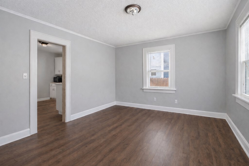 1404 18th Street Columbus, GA 31901 - Photo 4 of 20 an empty room with wooden floor and windows