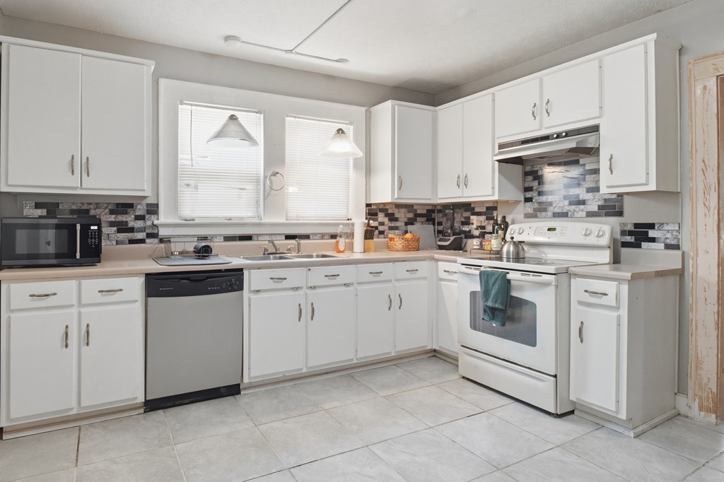 1404 18th Street Columbus, GA 31901 - Photo 5 of 20 a kitchen with cabinets appliances a sink and a window