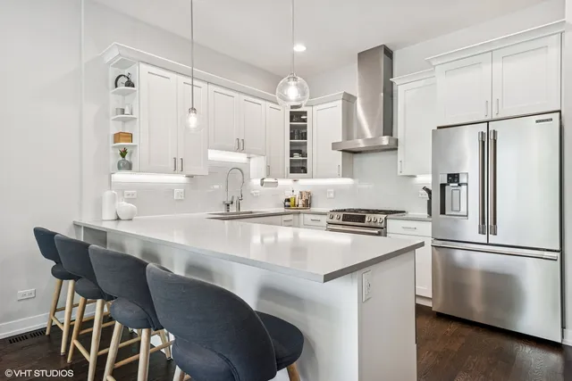 a kitchen with stainless steel appliances granite countertop a sink stove and refrigerator