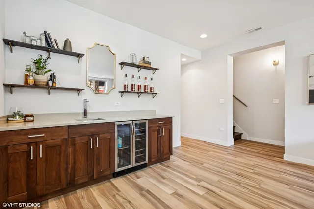a kitchen with stainless steel appliances granite countertop a sink and wooden floor