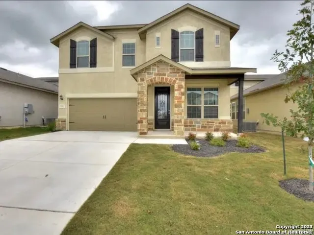 a front view of a house with a yard