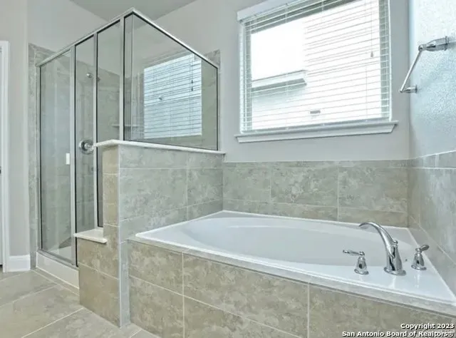 a bathroom with a bathtub and a shower