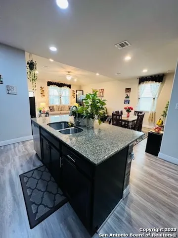 a kitchen with counter top space and wooden floor