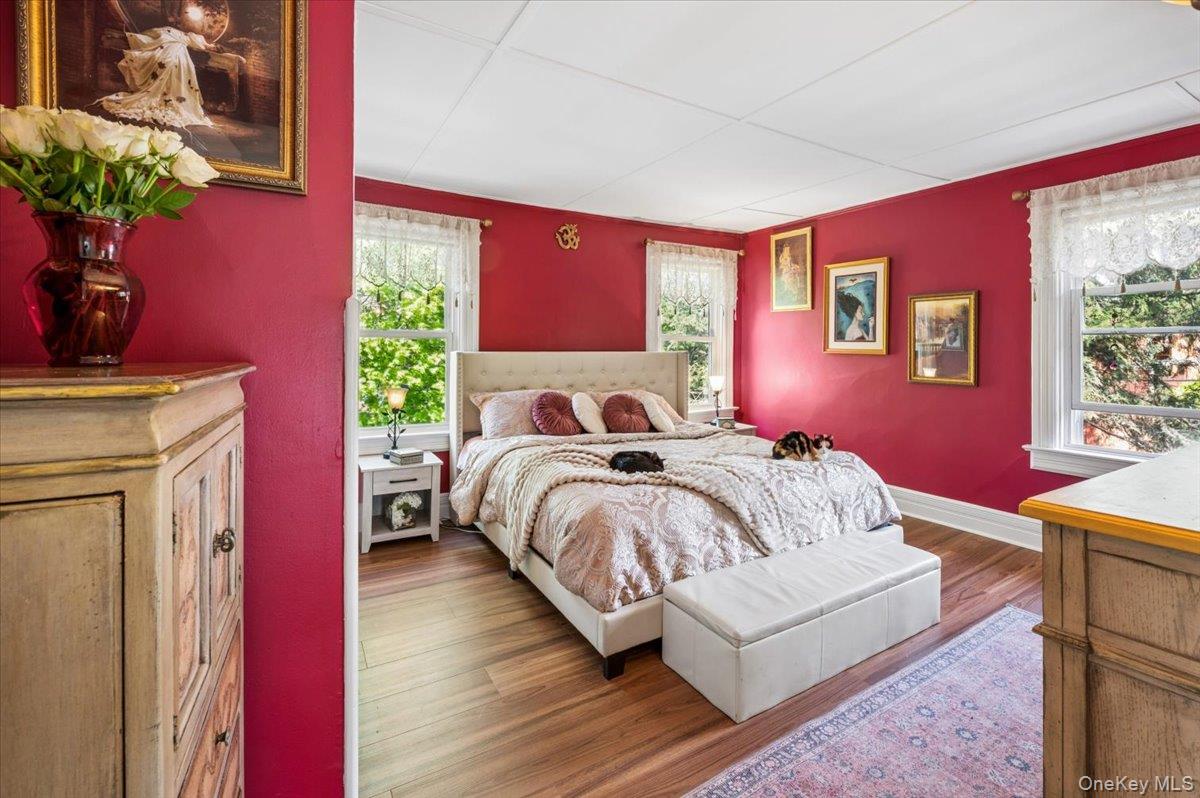 46 Bedford Road Katonah, NY 10536 - Photo 14 of 34 Spacious room featuring wood-finish flooring, bright red walls, and white trim