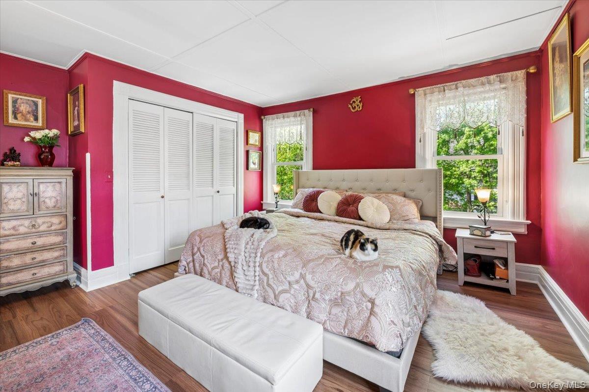 46 Bedford Road Katonah, NY 10536 - Photo 16 of 34 Bedroom featuring wood-finish flooring, white baseboards, and two windows with white trim