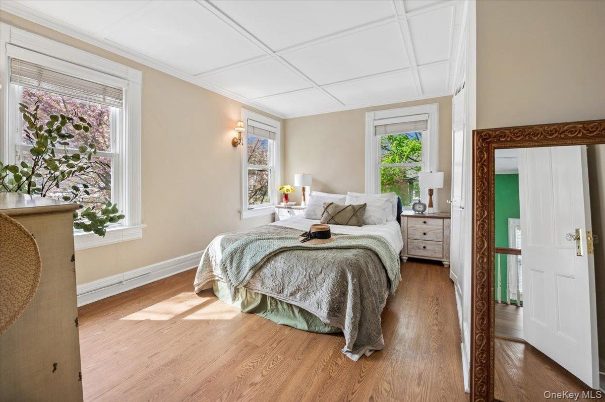 46 Bedford Road Katonah, NY 10536 - Photo 19 of 34 Bedroom featuring wood-finish flooring, two windows with blinds, and white trim