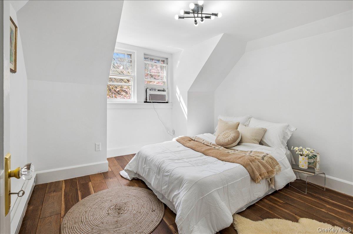 46 Bedford Road Katonah, NY 10536 - Photo 21 of 34 Room featuring wood-finish flooring, white walls, and a contemporary ceiling light fixture