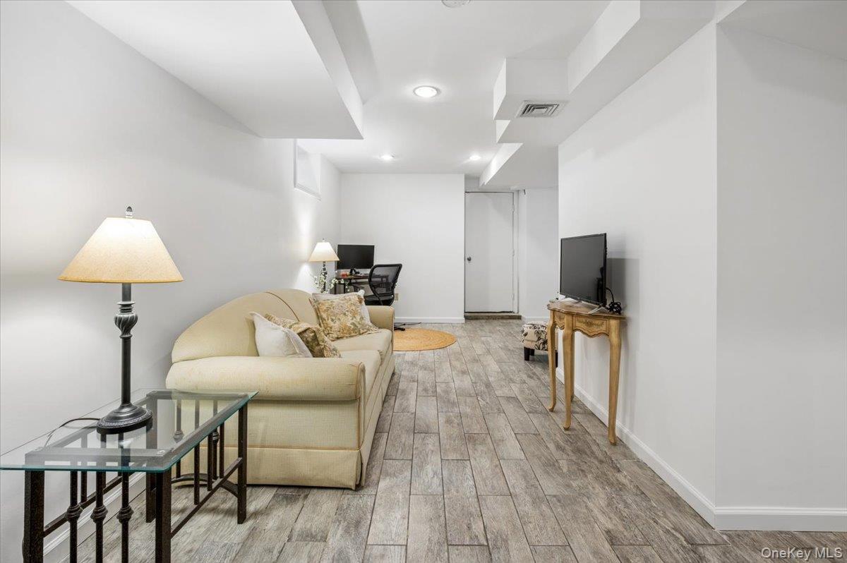 46 Bedford Road Katonah, NY 10536 - Photo 23 of 34 Expansive finished room featuring wood-finish flooring, recessed lighting, and crisp white walls