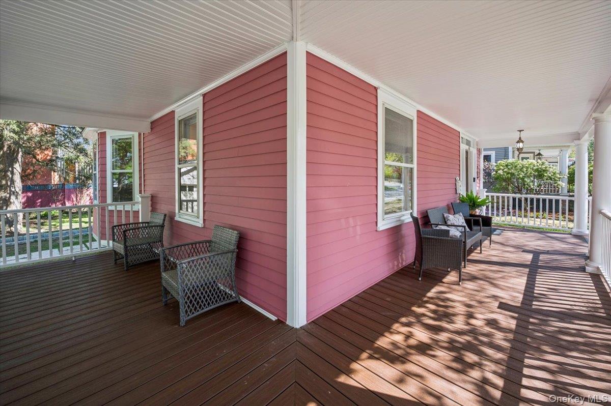 46 Bedford Road Katonah, NY 10536 - Photo 26 of 34 Expansive covered porch featuring a rich wood-finish deck, white railing, and a beadboard ceiling