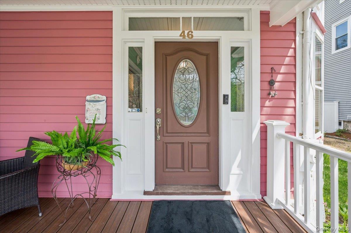 46 Bedford Road Katonah, NY 10536 - Photo 3 of 34 Inviting front entry featuring a paneled door with an oval leaded glass insert, flanked by sidelight windows and a transom window