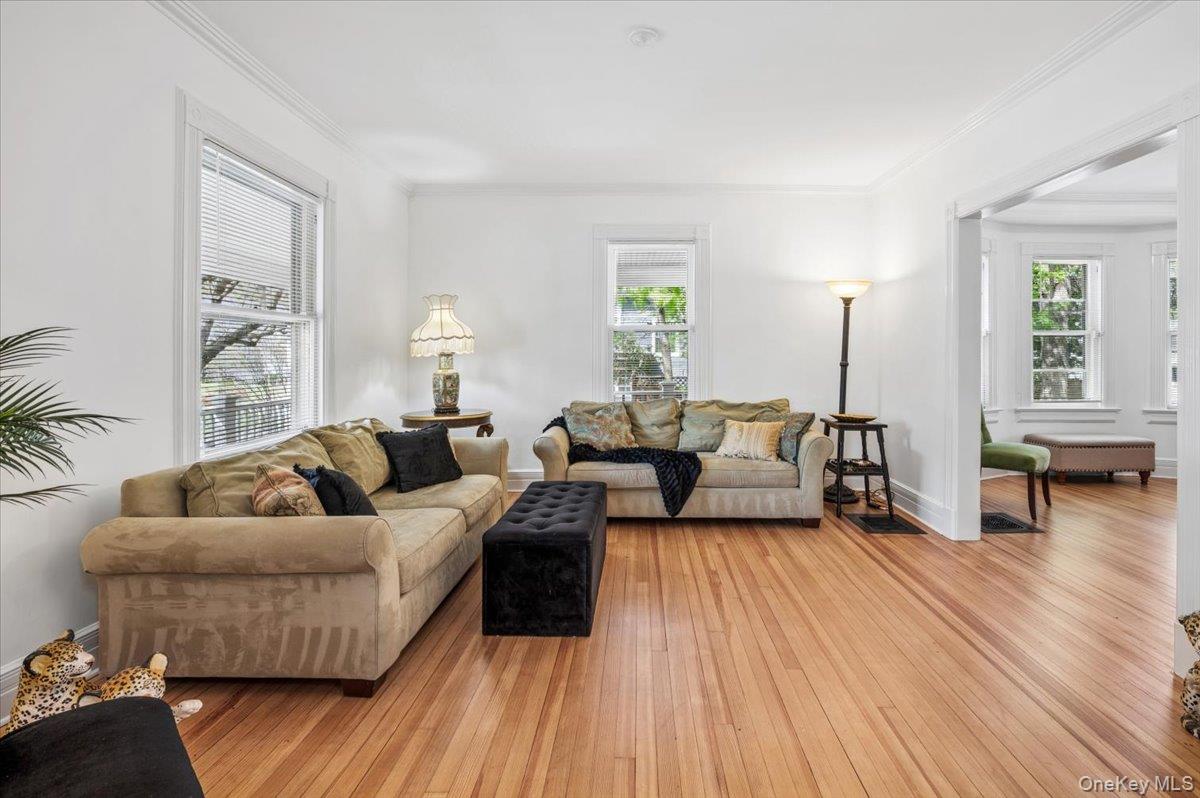 46 Bedford Road Katonah, NY 10536 - Photo 7 of 34 Living area featuring wood-finish flooring, white walls, and bright window openings