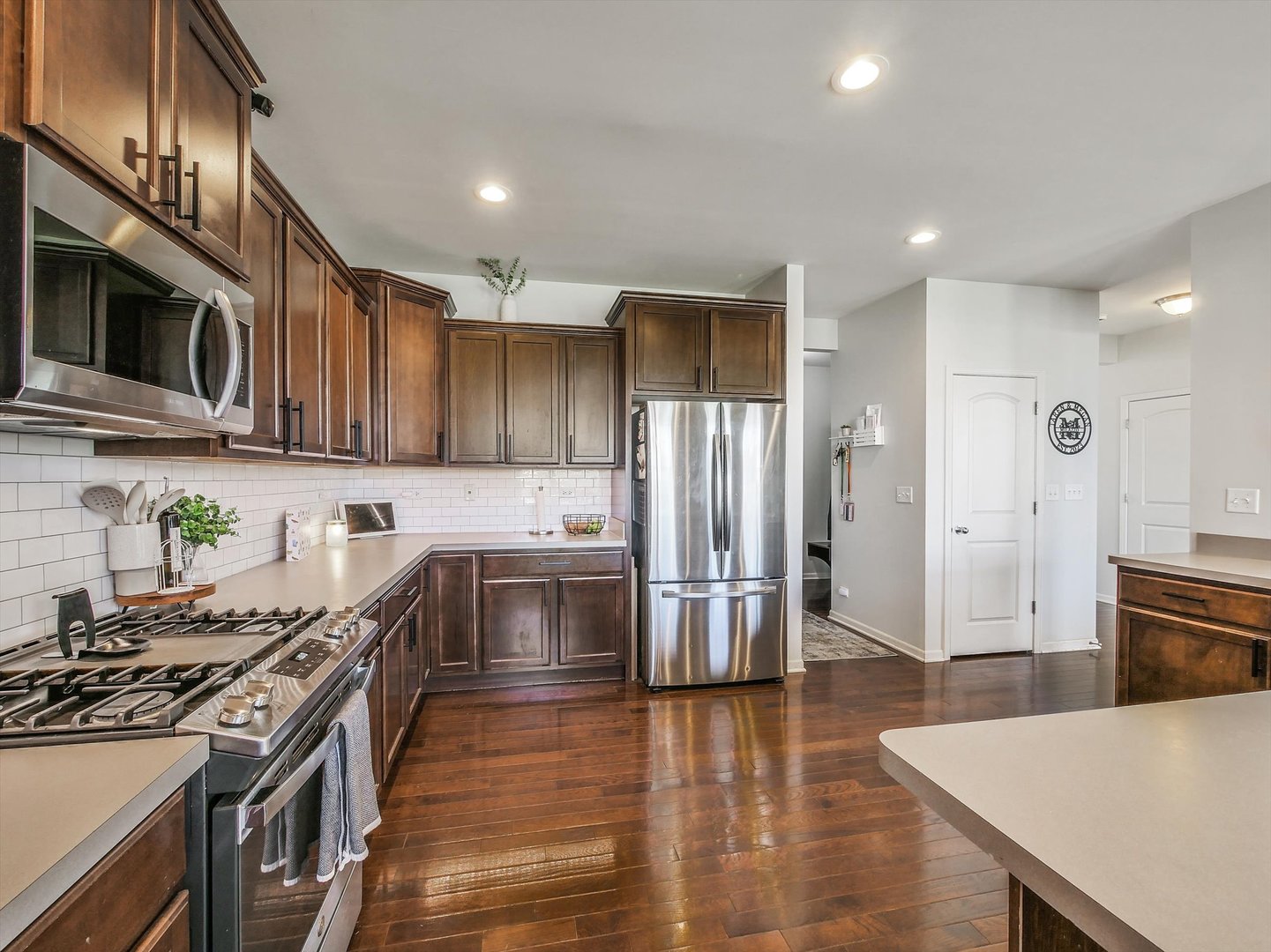 32 Catamaran Circle Pingree Grove, IL 60140 - Photo 14 of 46 a kitchen with stainless steel appliances a stove a sink a refrigerator and cabinets
