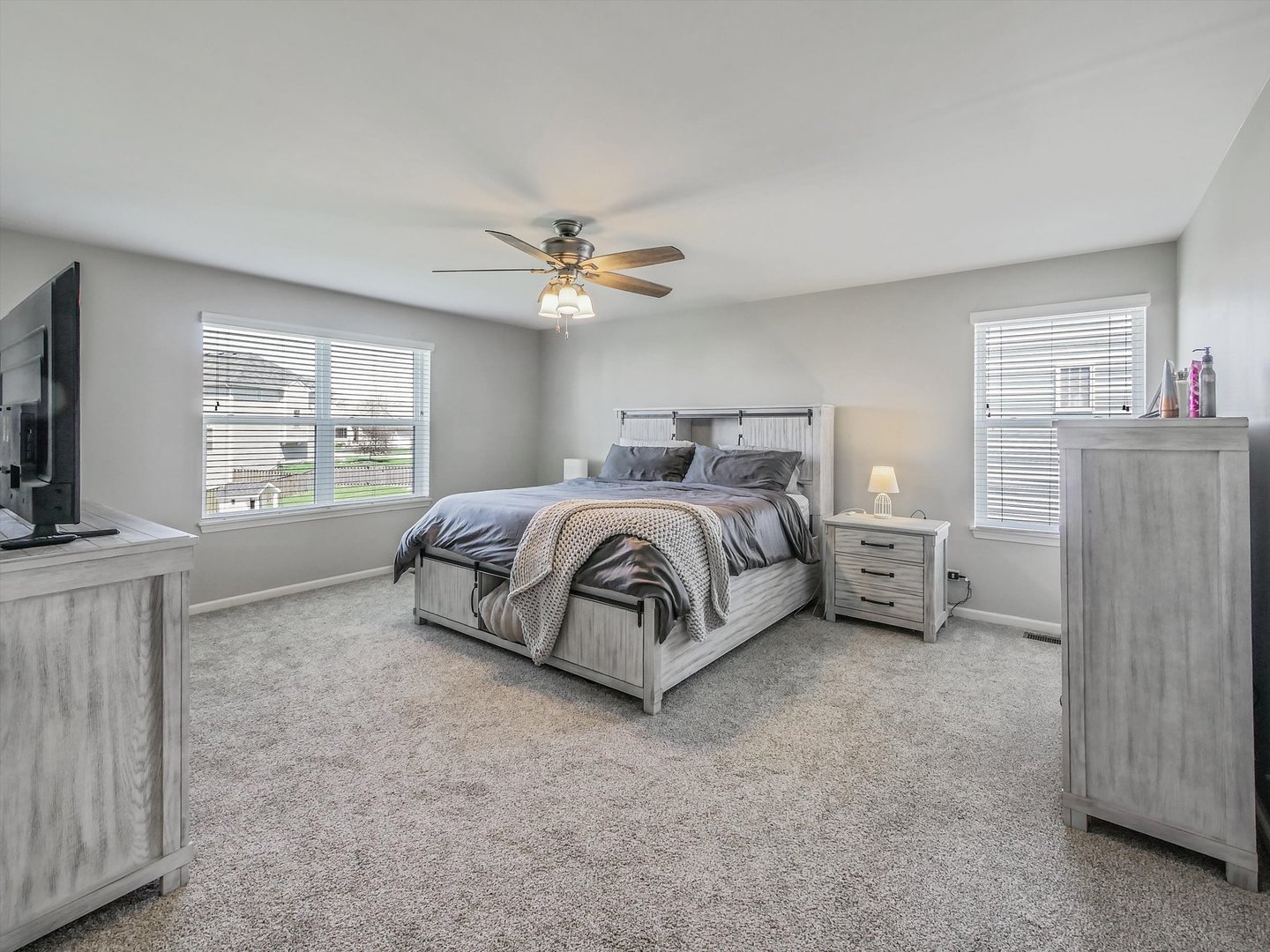 32 Catamaran Circle Pingree Grove, IL 60140 - Photo 19 of 46 a spacious bedroom with a bed and a tv on the dresser