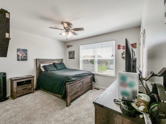 32 Catamaran Circle Pingree Grove, IL 60140 - Photo 26 of 46 a bedroom with a bed dresser and a flat tv screen