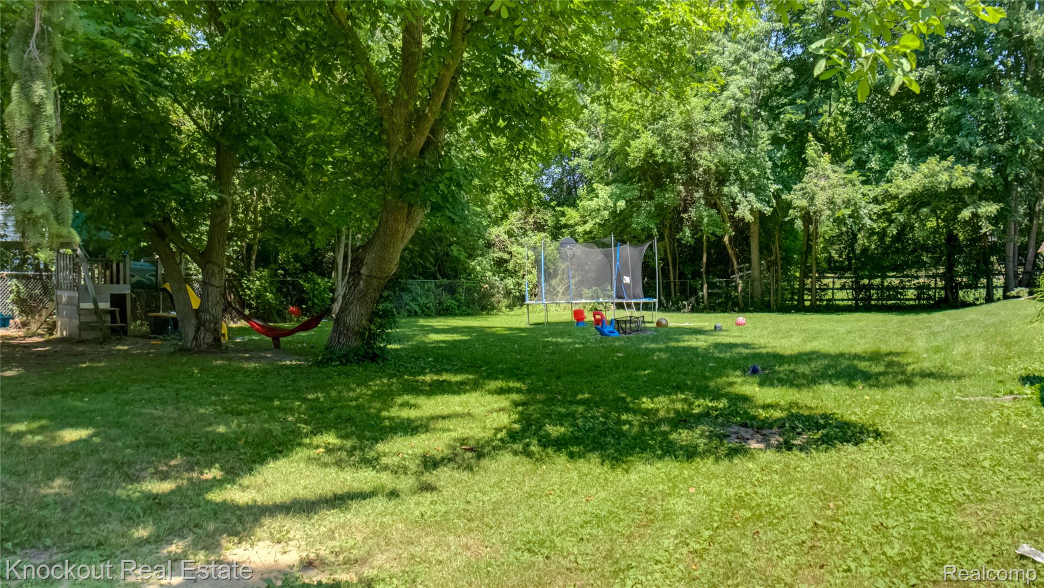 4195 Williamson Road Saginaw, MI 48601 - Photo 45 of 50 Expansive green lawn surrounded by mature trees, offering a natural setting