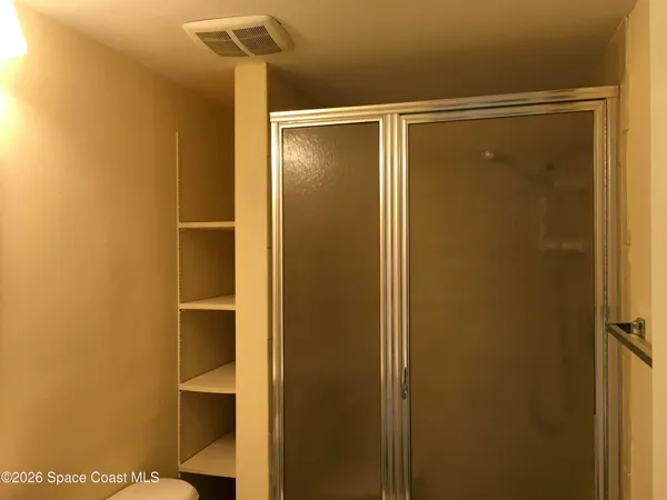 a bathroom with a glass shower door