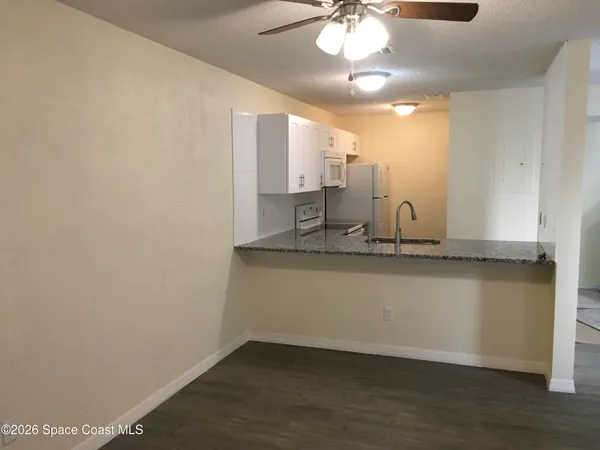 a view of a bathroom with a sink and a mirror
