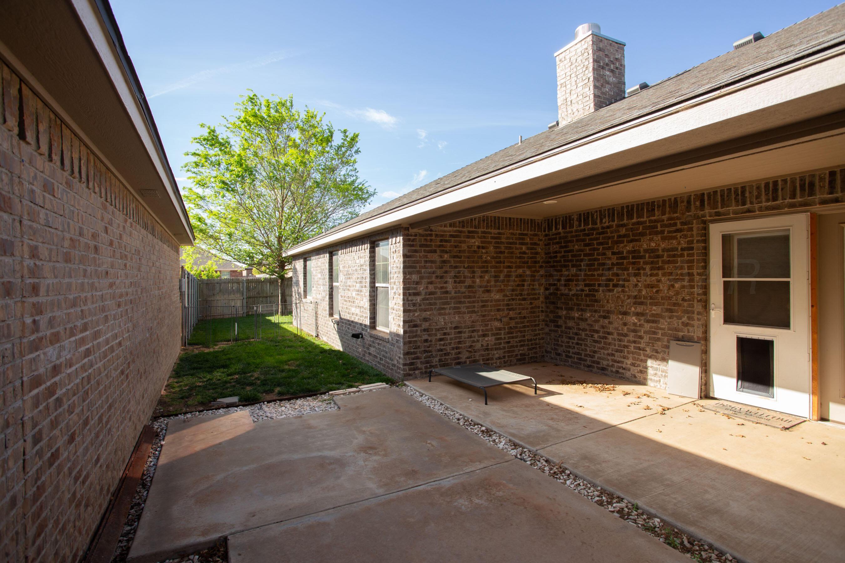 9505 Perry Avenue Amarillo, TX 79119 - Photo 20 of 21 a front view of a house with a yard and garage