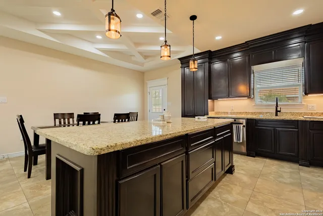 a kitchen with a stove a sink and a refrigerator