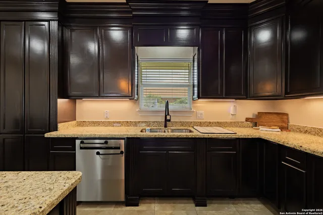 a kitchen with a sink and a wooden cabinets