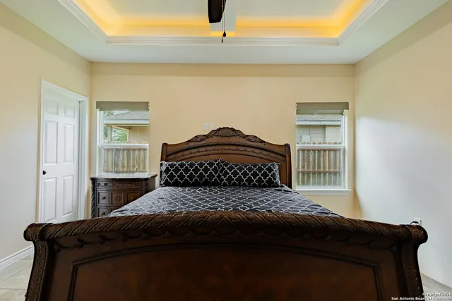 a bedroom with a bed and a window