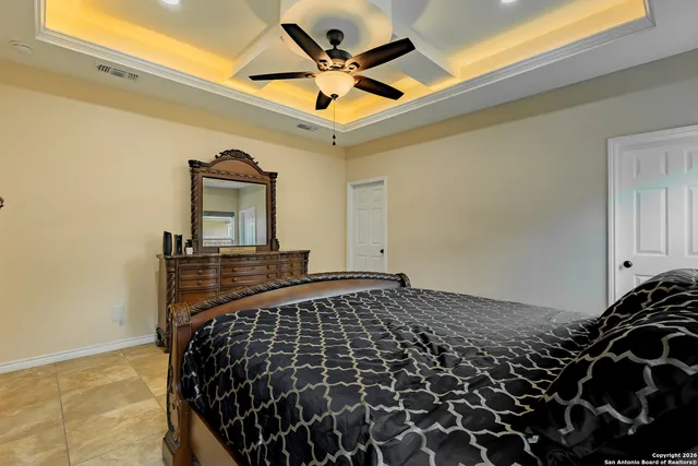 a bedroom with a bed and a ceiling fan