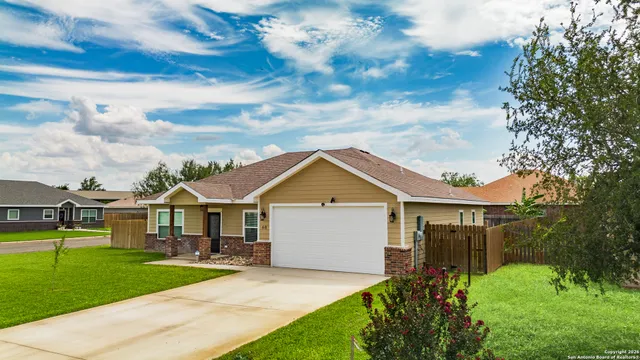 a front view of house with yard and green space