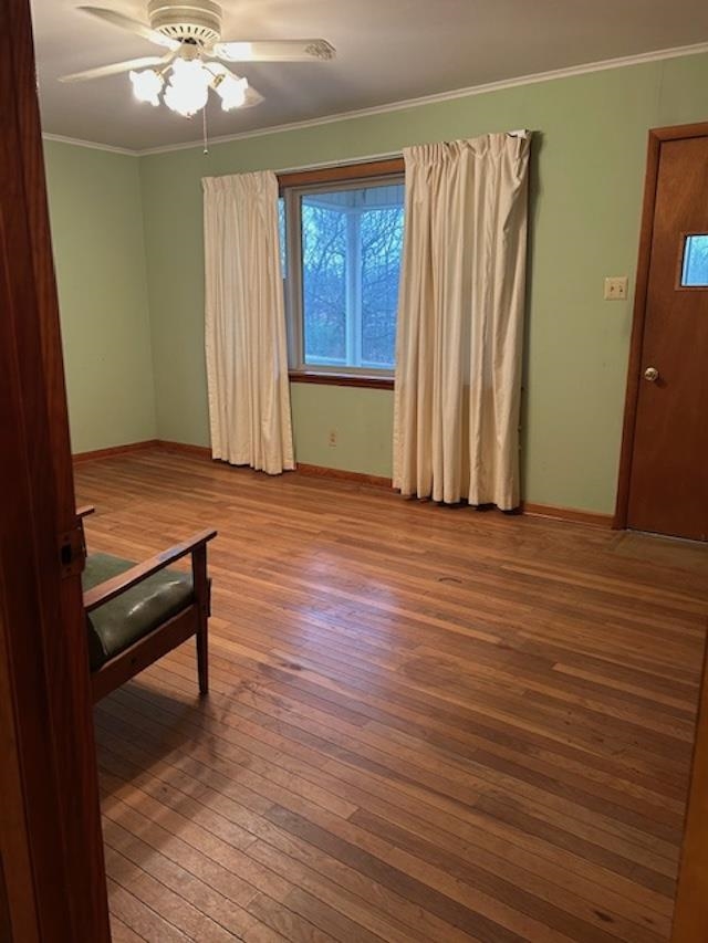 7030 Asbury Glimp Road Ripley, TN 38063 - Photo 12 of 17 Empty room featuring ornamental molding, wood-type flooring, and ceiling fan