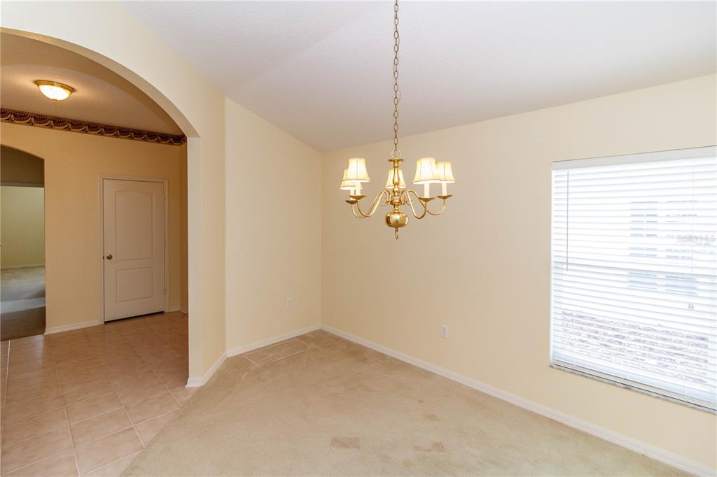 1747 Ravenridge Street Wesley Chapel, FL 33543 - Photo 11 of 35 a view of a livingroom with a chandelier wooden floor and chandelier