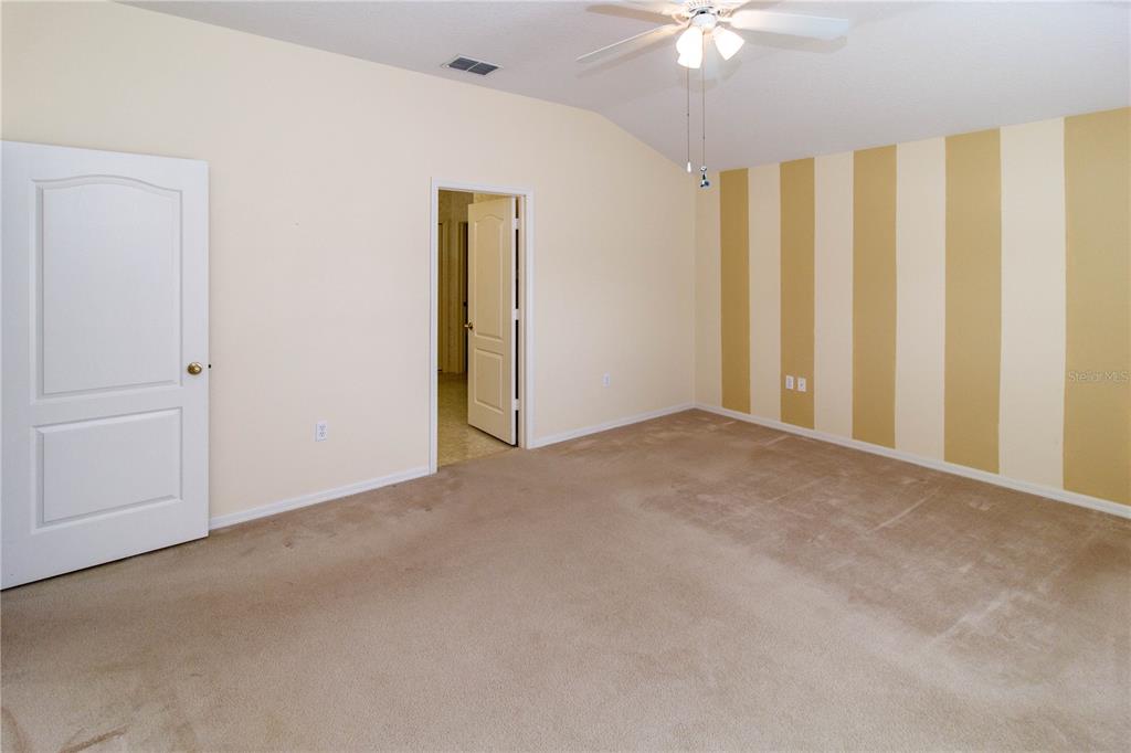 1747 Ravenridge Street Wesley Chapel, FL 33543 - Photo 23 of 35 an empty room with a ceiling fan and a window