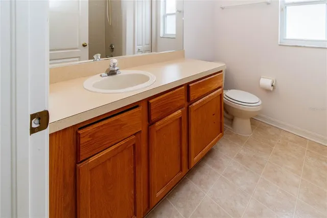 a bathroom with a sink a toilet and a mirror