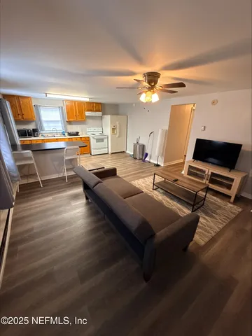 a view of a workspace with furniture and a rug