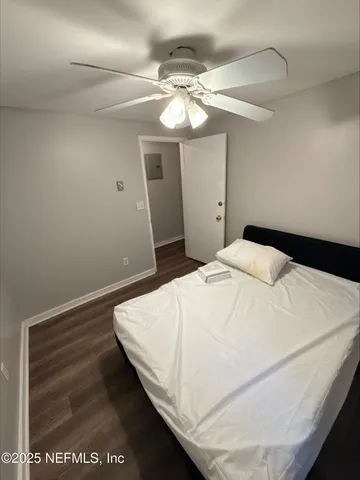 a bedroom with a bed and chandelier